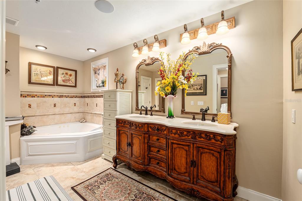 5015 Southwest 91 Terrace Gainesville, FL 32608 - Photo 41 of 61 a spacious bathroom with a granite countertop toilet sink and mirror