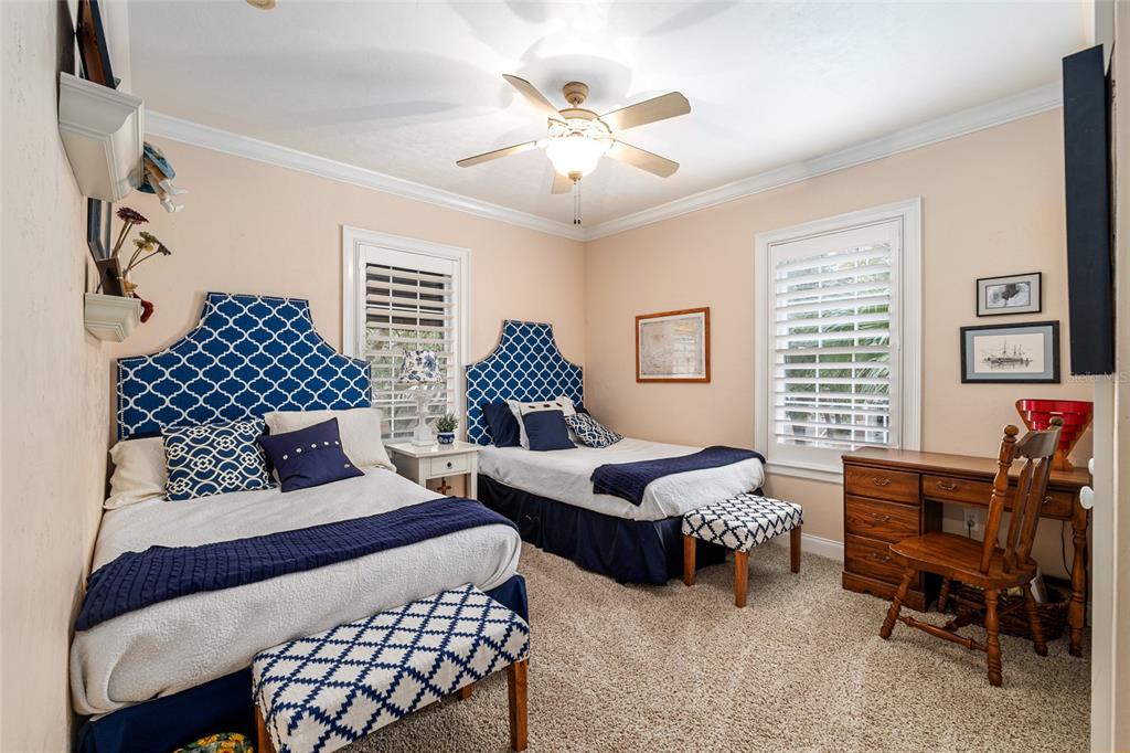 5015 Southwest 91 Terrace Gainesville, FL 32608 - Photo 48 of 61 a bedroom with two beds and a chandelier