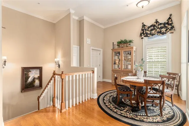 a dining room with furniture a chandelier and wooden floor