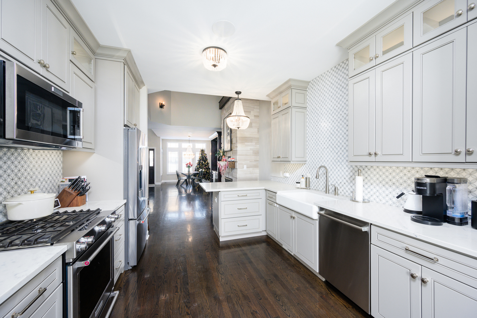 232 North Addison Avenue Elmhurst, IL 60126 - Photo 6 of 28 a kitchen with a sink dishwasher stove and white cabinets with wooden floor