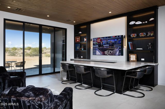 a living room with furniture a rug and a large window