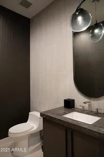 a bathroom with a toilet and a mirror