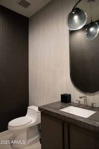 a bathroom with a toilet and a mirror