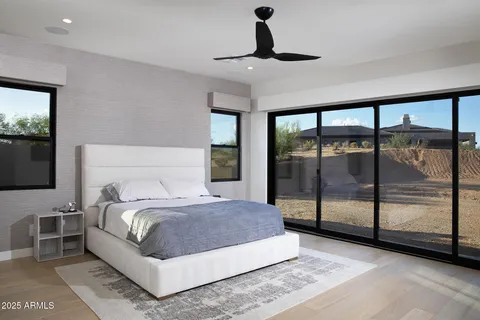 a bedroom with a large bed and a flat tv screen on dresser