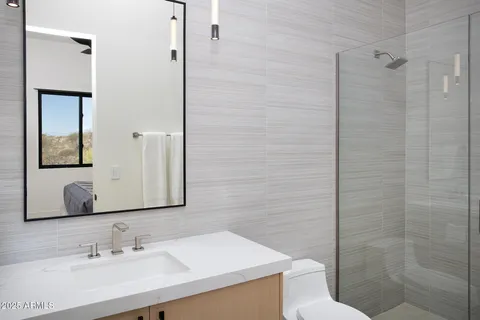 a bedroom with a bed and painting on the wall