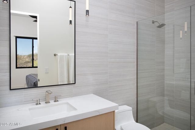 a bedroom with a bed and painting on the wall