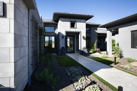 a view of a patio with a table and chairs under an umbrella next to a lake
