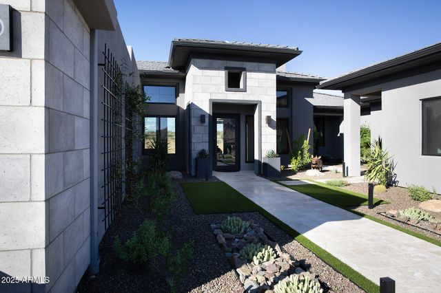 a view of a patio with a table and chairs under an umbrella next to a lake
