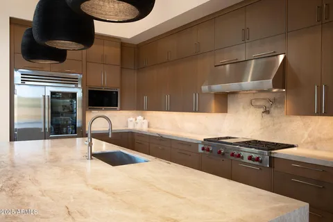 a kitchen with a sink cabinets and appliances