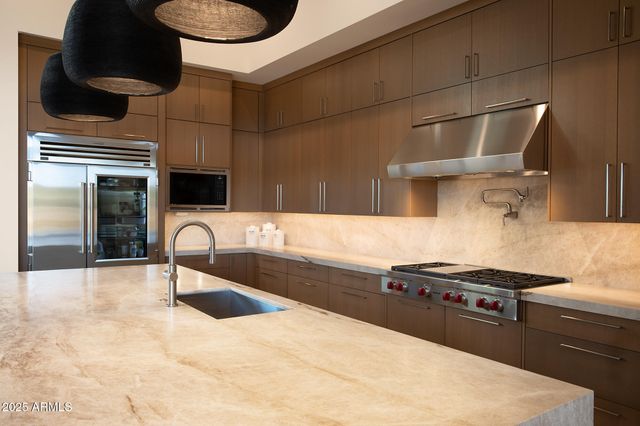 a kitchen with a sink cabinets and appliances