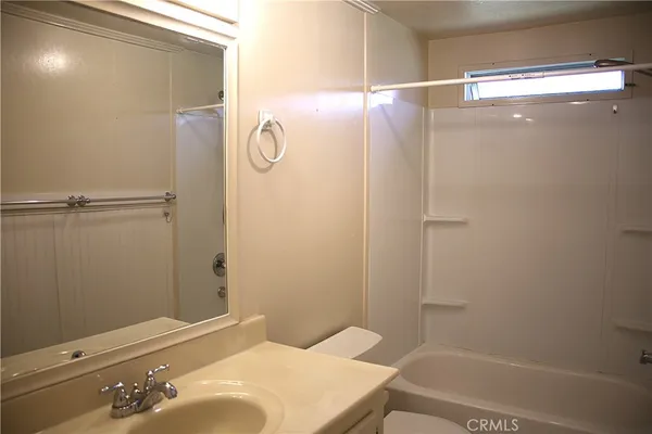 wooden bathroom with a sink and mirror