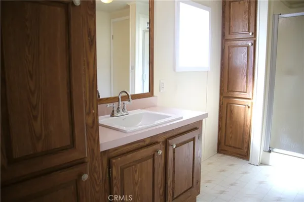 a view of a room with wooden floor and bathroom