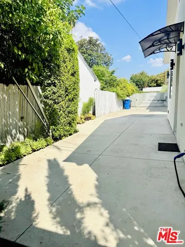 a view of a street with potted plants