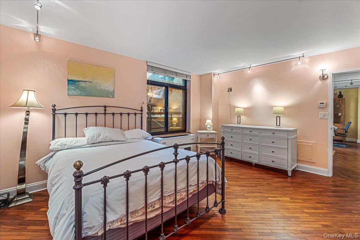 400 East 70th Street, Unit 201 Manhattan, NY 10021 - Photo 11 of 21 a bedroom with furniture and a window