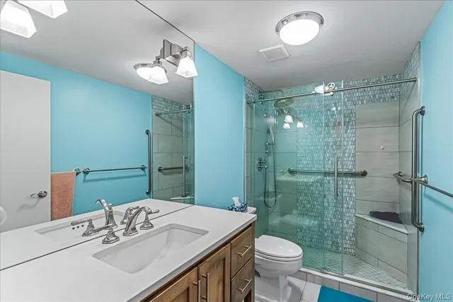 a bathroom with a sink toilet and shower