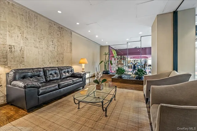 a living room with furniture and a potted plant