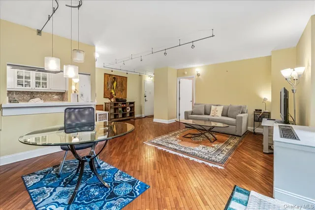 a living room with fireplace furniture and a chandelier
