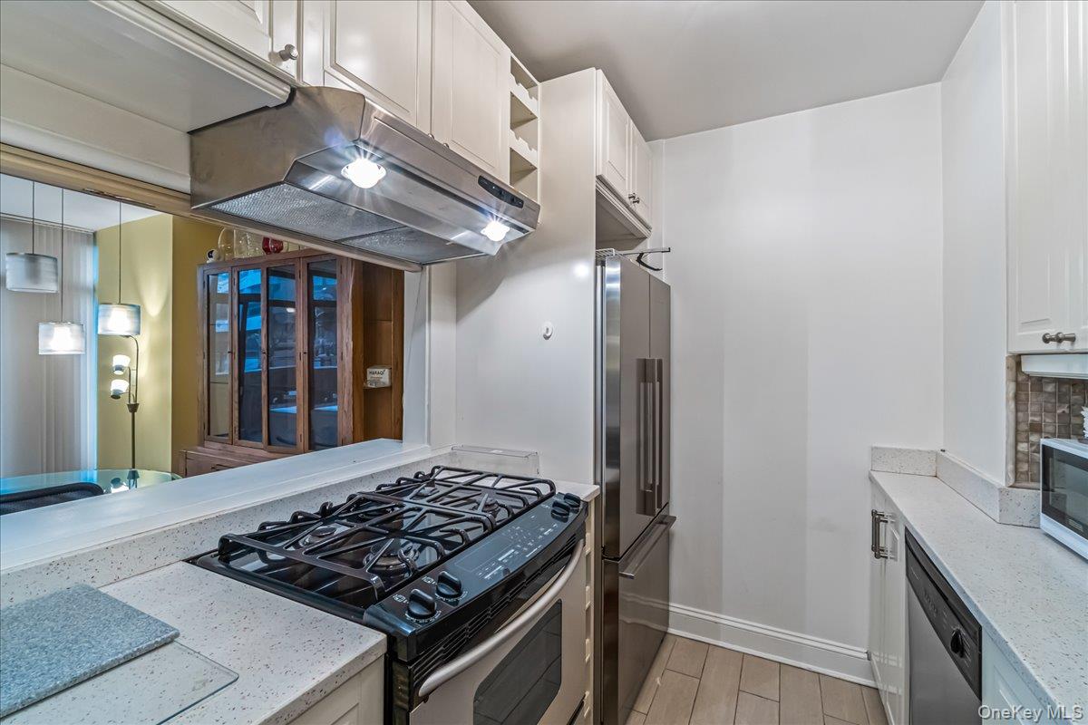 400 East 70th Street, Unit 201 Manhattan, NY 10021 - Photo 6 of 21 a kitchen with stainless steel appliances granite countertop a sink stove and refrigerator