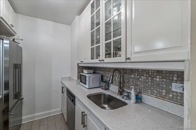a kitchen with a sink and cabinets