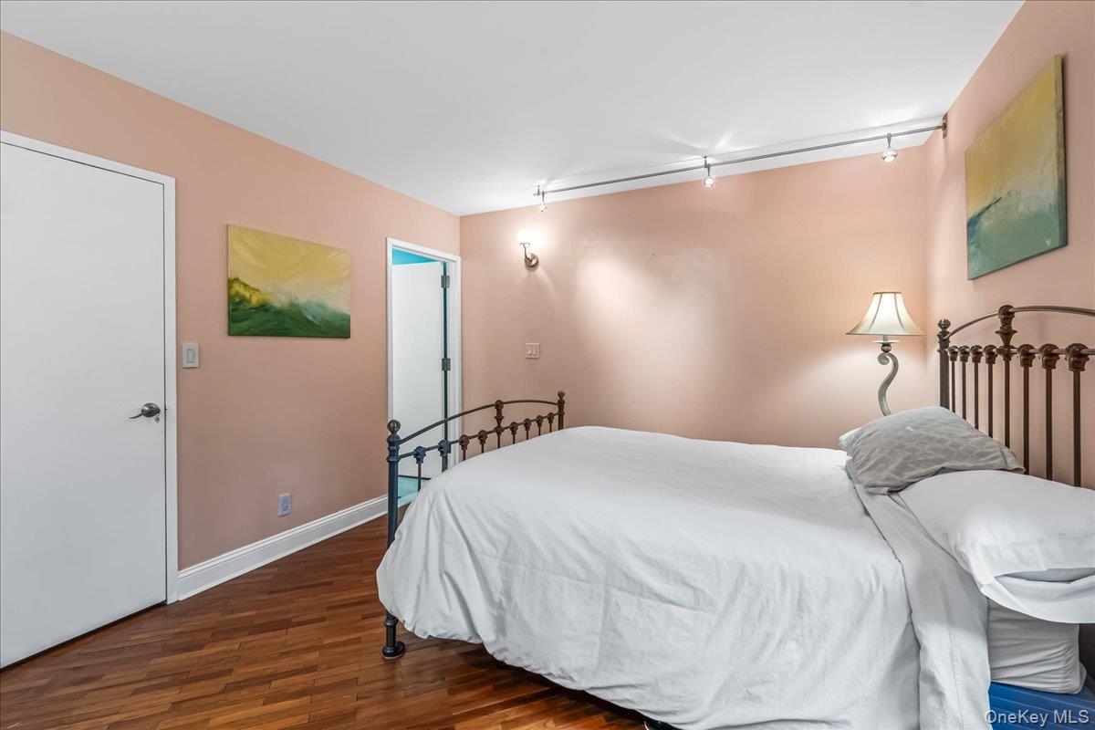 400 East 70th Street, Unit 201 Manhattan, NY 10021 - Photo 10 of 21 a bedroom with a bed and a mirror