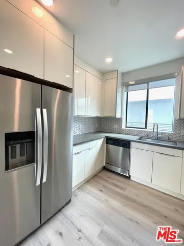 a kitchen with stainless steel appliances granite countertop a stove and a sink