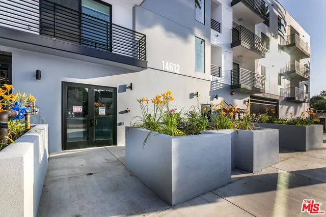 a view of a house with potted plants