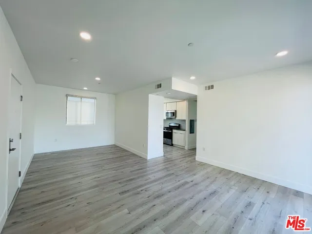 a view of a kitchen cabinets and wooden floor