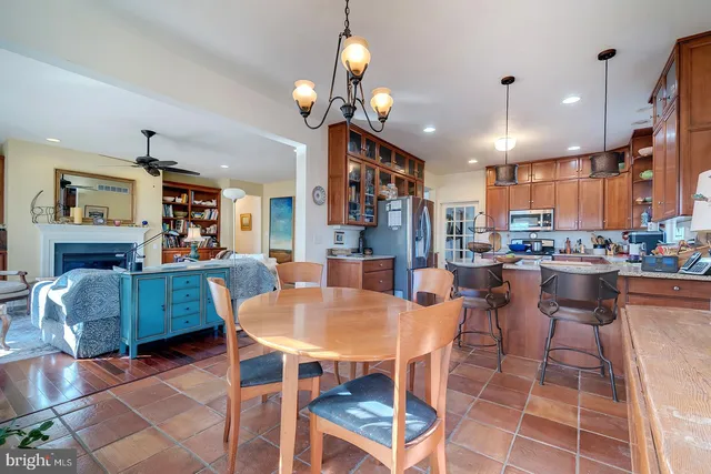 a dining area with a table chairs and a kitchen view