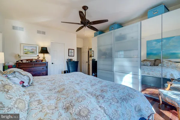 a spacious bedroom with a bed and a couch