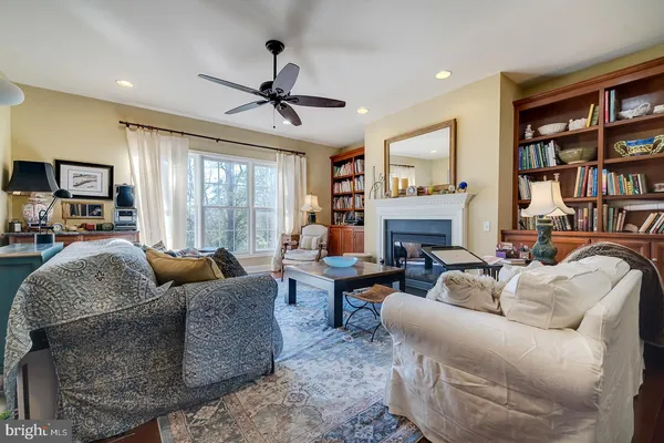 a living room with furniture fireplace and a large window