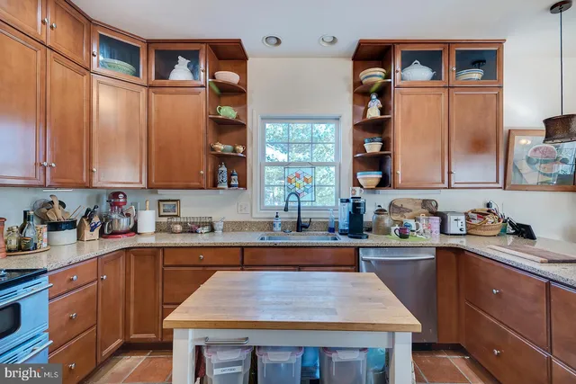 a kitchen with a sink a stove and cabinets