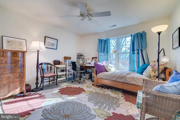 a bedroom with a bed and a night stand