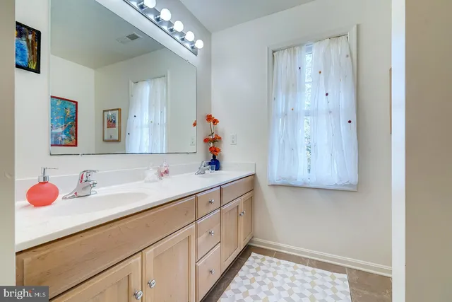a spacious bedroom with a bed and a chandelier