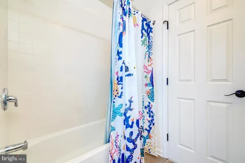 a bathroom with a toilet a sink and a mirror