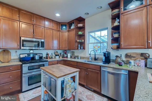 a kitchen with a sink stove top oven and cabinets