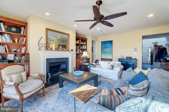 a living room with furniture a rug and a fireplace