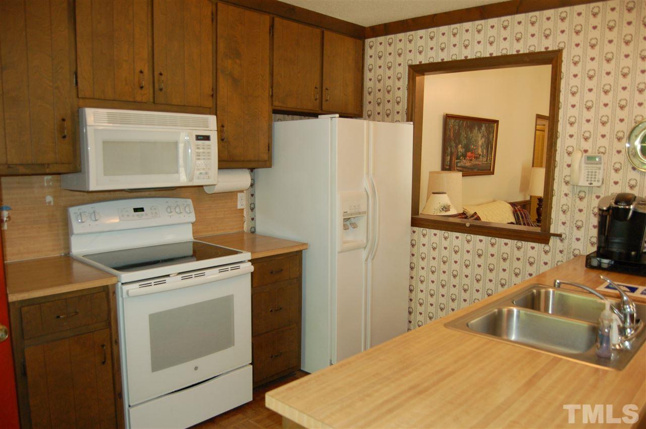 804 Valetta Road Durham, NC 27712 - Photo 9 of 28 a kitchen with a stove a refrigerator and a sink