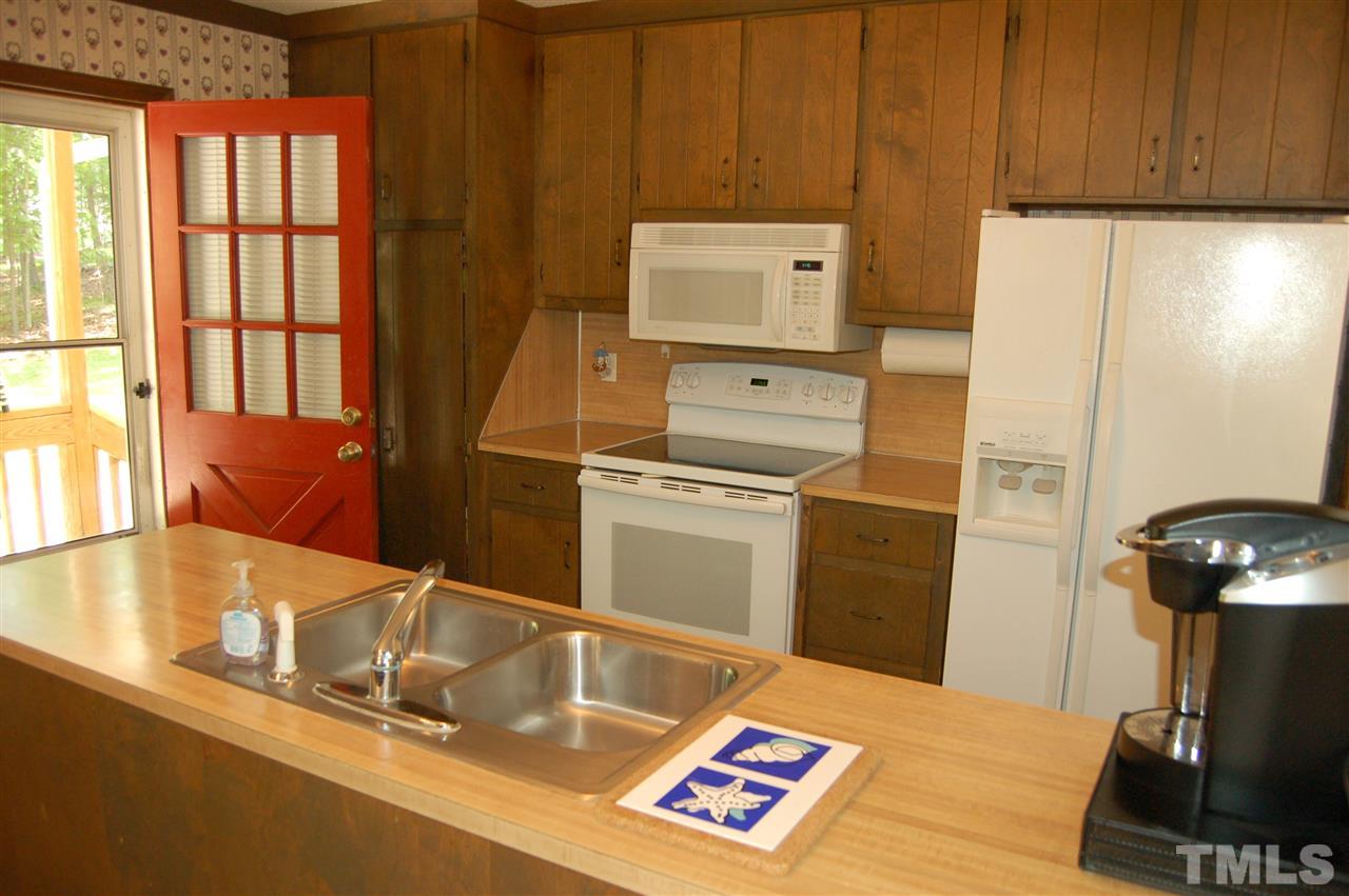 804 Valetta Road Durham, NC 27712 - Photo 10 of 28 a kitchen with a refrigerator and a stove top oven