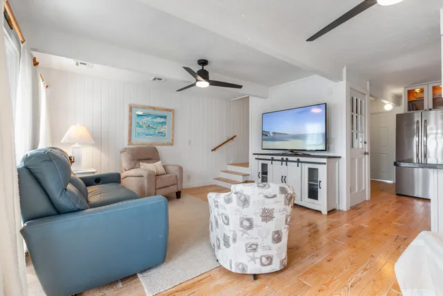 a living room with furniture a dining table and a fireplace