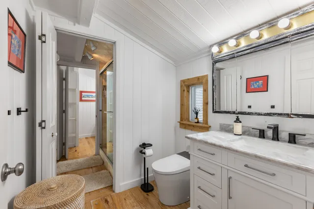 a bathroom with a toilet sink and shower