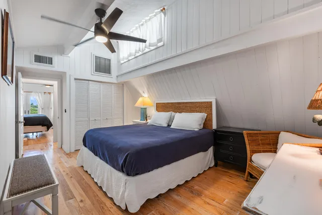 a bedroom with a bed and ceiling fan