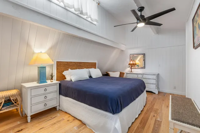 a bedroom with a bed and a night stand