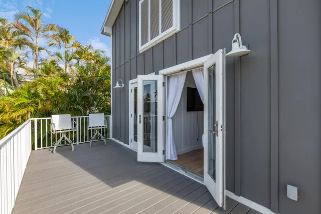 a view of a balcony with wooden floor and fence