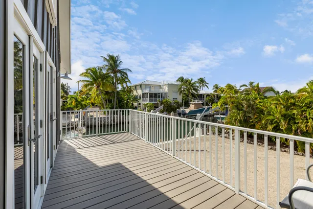 a balcony with wooden floor and city view