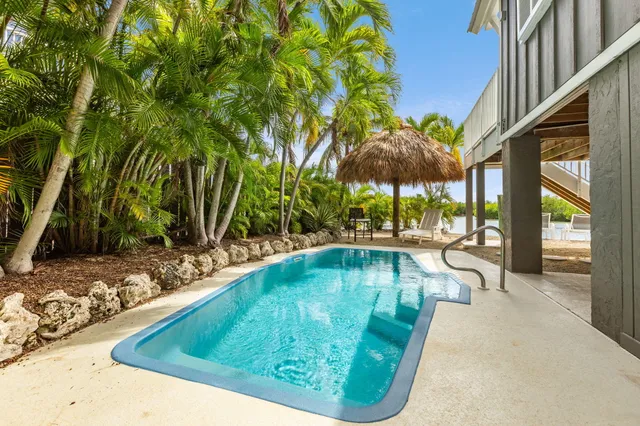 a swimming pool with outdoor seating and yard