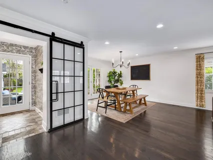 a living room with furniture flat screen tv and wooden floor