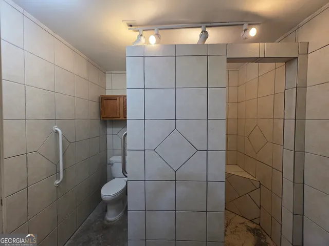 a bathroom with a toilet and a shower