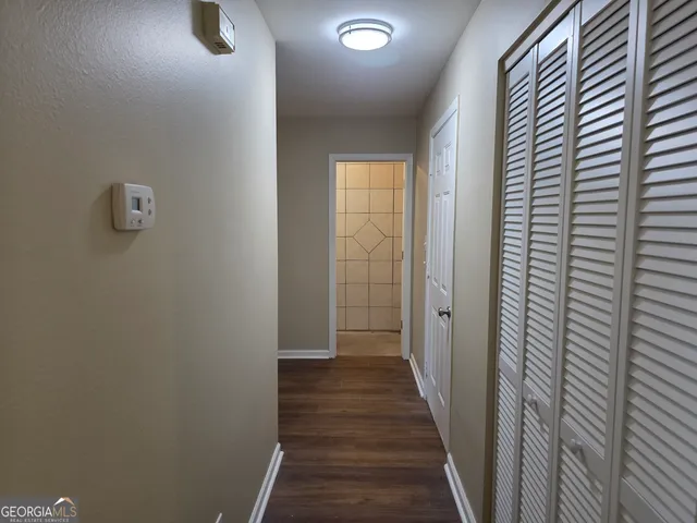 a view of a hallway with wooden floor