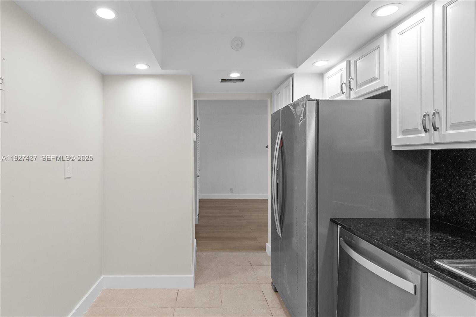 9511 Collins Avenue, Unit 806 Surfside, FL 33154 - Photo 16 of 32 a kitchen with metallic refrigerator freezer and a sink