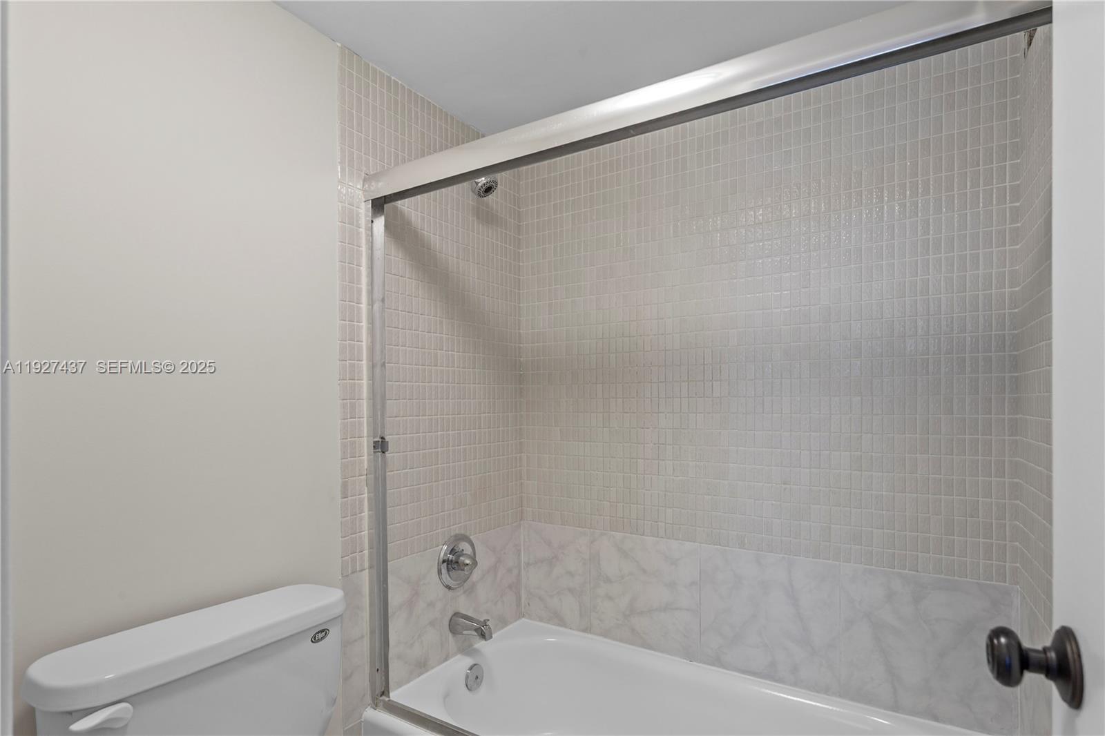 9511 Collins Avenue, Unit 806 Surfside, FL 33154 - Photo 19 of 32 a bathroom with a shower and a toilet